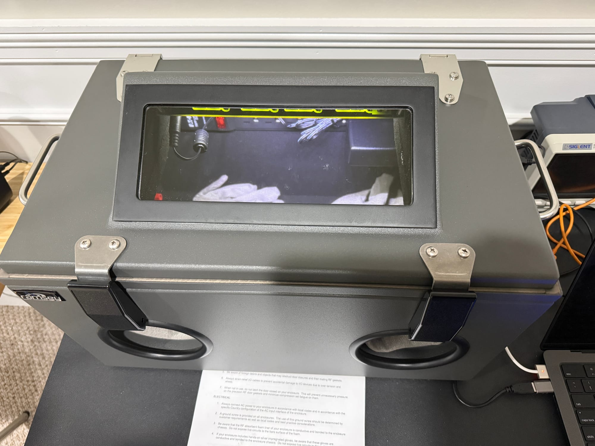 Ramsey STE3000M RF shielded test enclosure on workbench, door closed