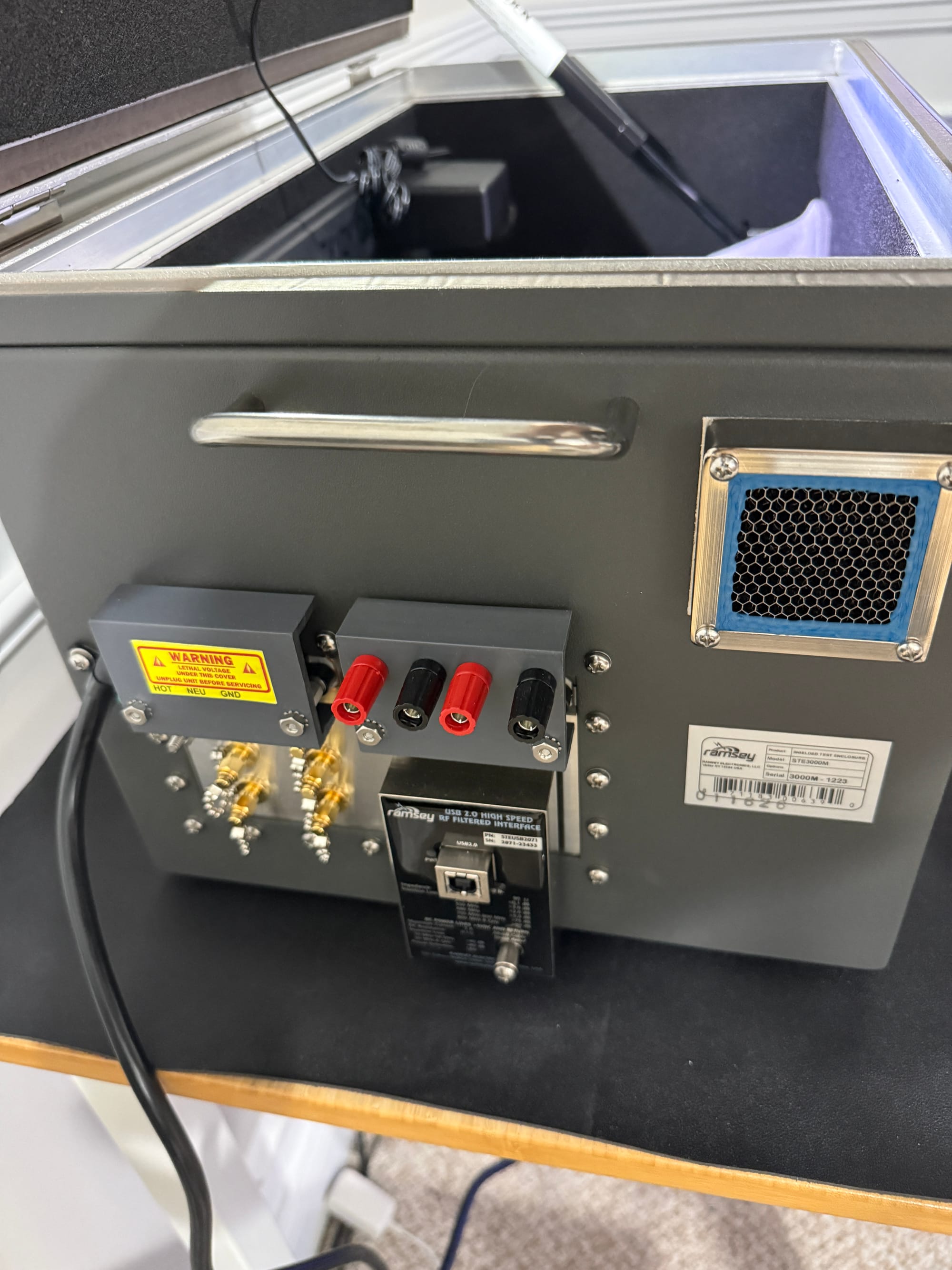 Close-up of the Ramsey STE3000M left I/O panel showing USB feedthrough, SMA connectors, and banana jacks